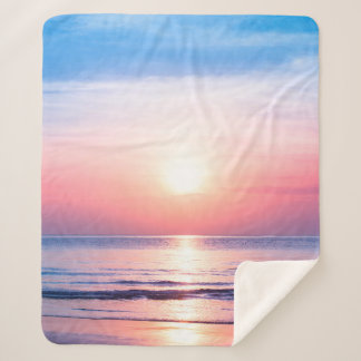 Beautiful morning sunrise, blue sea, pink sky, whi sherpa blanket