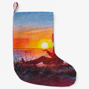Beautiful ocean sunset. Portrait of young woman as Small Christmas Stocking