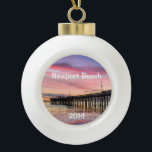 Beautiful Sunset at Newport Beach Ceramic Ball Christmas Ornament<br><div class="desc">This ornament makes a unique keepsake to remember any visit to fabulous Newport Beach.  Change the date to the current year.  The font style can be changed as well as the size,  colour and location.  Three options for the back image also.</div>