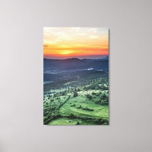 Beautiful sunset behind green fields canvas print (Front)