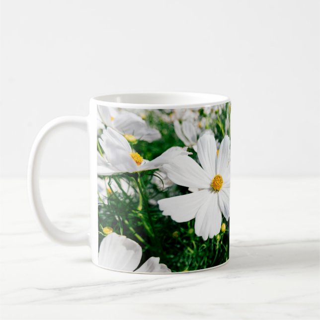 Beautiful white cosmos flowers blooming in gardena coffee mug (Left)