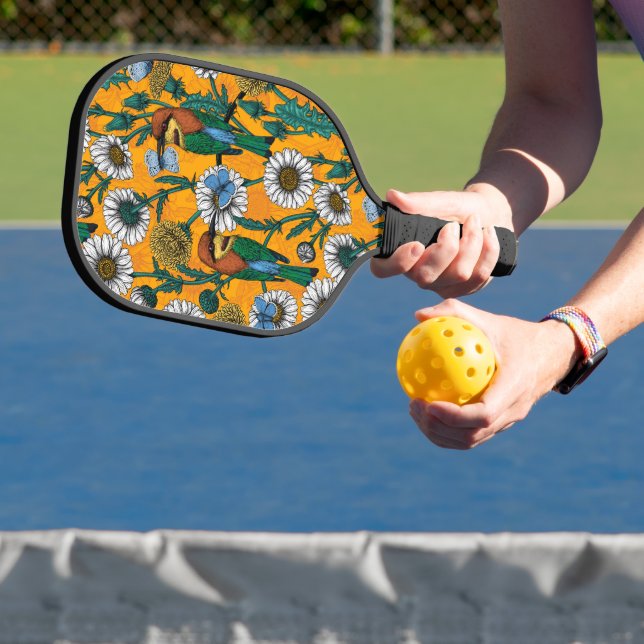 Bee-eaters, blue butterflies and daisies on orange pickleball paddle (Insitu)