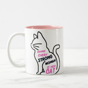 Behind every strong woman is her cat Two-Tone coffee mug