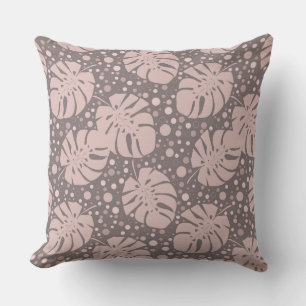 Beige monstera leaves on brown polka dot cushion