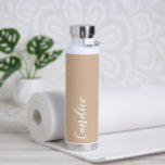 Beige Personalised Wedding Bridesmaid Water Bottle<br><div class="desc">Gift your wedding bridesmaid or maid of honour with this trendy, vacuum Insulated water bottle that features her name in white, stylised script on a beige colour background designed to match your wedding colour scheme. Personalise bottle by editing and replacing name with your own as desired. Select your water bottle...</div>