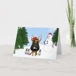 Belgian Malinois Winter Snow Holiday Card<br><div class="desc">Unique Malinois winter wonderland design. Belgian Malinois with a bit of snow on his nose and surrounded by rabbits. Happy snowman looks on. To ward off the cold the Belgian Malinois has on a scarf and hat that are the colours of his country.</div>