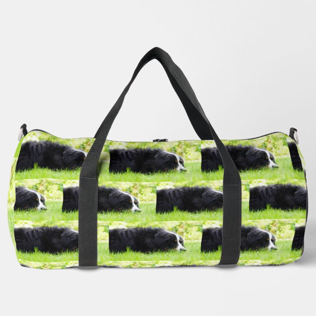 bernese mountain dog laying in grass duffle bag (Front)