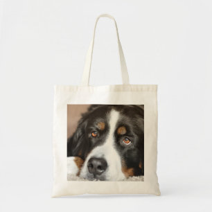 bernese mountain dog laying tote bag