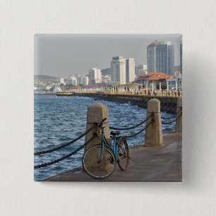 Bicycle at waterfront with Yantai city skyline, 15 Cm Square Badge