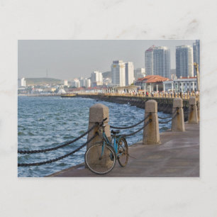 Bicycle at waterfront with Yantai city skyline, Postcard