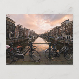 Bicycles at sunset in Amsterdam Postcard