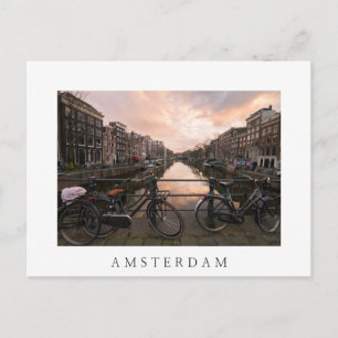 Bicycles at sunset in Amsterdam Postcard