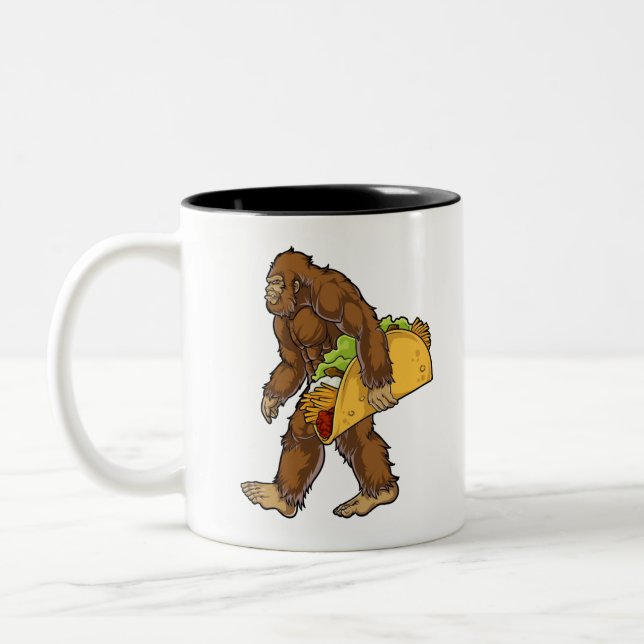 Bigfoot Sasquatch Carrying Taco Two-Tone Coffee Mug (Left)