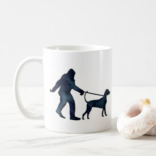 Bigfoot Walking a Bluetick Coonhound on a Leash Coffee Mug