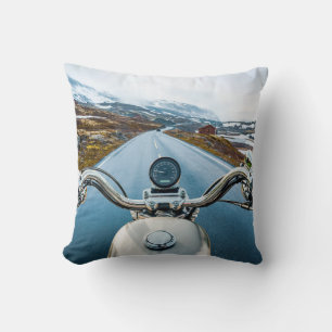 Biker rides a motorcycle on a slippery road throug cushion