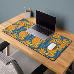 Bird of paradise flowers on orange desk mat