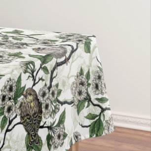 Birds and cherry blossom on white tablecloth