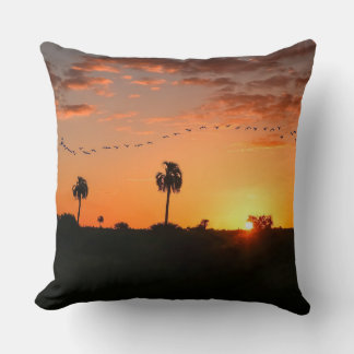 Birds crossing at sunset cushion