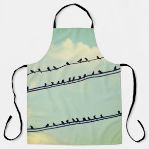 Birds on wires, vintage blue sky. apron
