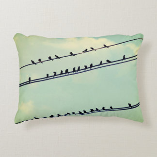 Birds on wires, vintage blue sky. decorative cushion
