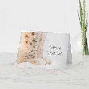 Birthday card with soft golden lynx paws in snow
