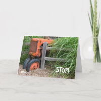 Birthday old orange tractor on fence