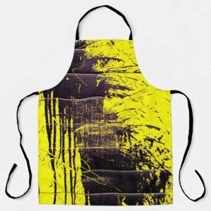 Black abstract splatter paint drips on a bright ye apron