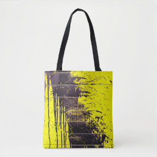 Black abstract splatter paint drips on a bright ye tote bag