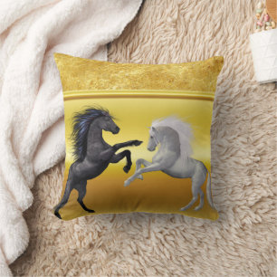 Black and a white Horse that are fighting gold Cushion