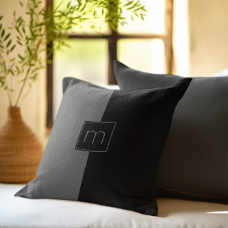 Black and grey split-screen geometric design cushion