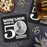 Black and white 50th birthday photo look who is  square paper coaster<br><div class="desc">Fiftieth birthday photo Wow look who is 50 party coasters in simple monotone black and white. Great idea for adding some fun, humour and a talking point to a 50th birthday party. Personalise with your own photo in the 0 of 50. Reads Wow look who is 50 and then add...</div>