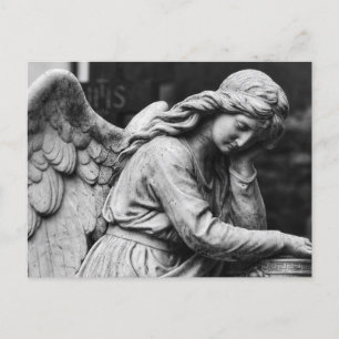 Black and white angel statue in a cemetery postcard