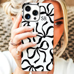 Black And White Bow Monogram iPhone 16 Pro Max Case<br><div class="desc">Dress up your phone in style with this chic and trendy black and white phone case! Featuring a playful pattern of hand-drawn bows and personalised with your monogram, this case is the perfect blend of fashion and function. Made from durable materials to protect your phone from everyday bumps and scratches....</div>