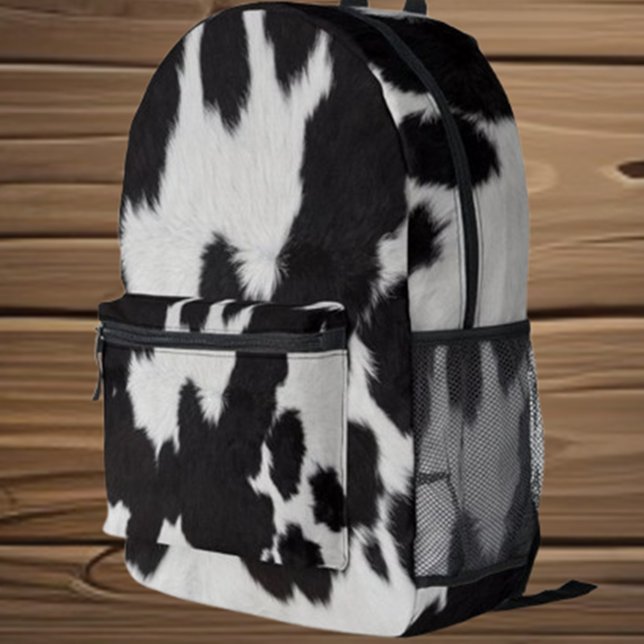 Black and White Cow Printed Backpack (Embrace your love for cows with the adorable Black and White Cow Printed Backpack by Love Cows.)