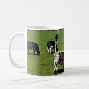 Black and white cows in field in Ireland Coffee Mug