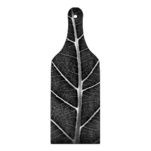 Black and white glowing leaf close-up cutting board