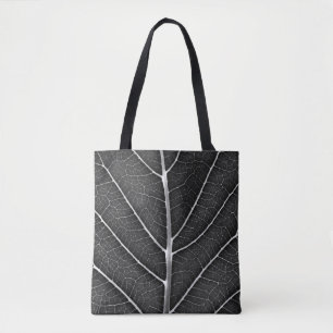 Black and white glowing leaf close-up tote bag