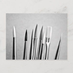 Black and white paint brushes design postcard