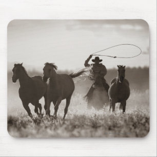 Black and White photo of a Cowboy Lassoing Horses Mouse Mat