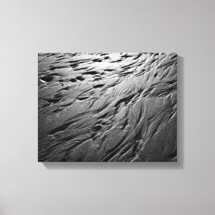 Black and white photo of sand patterns on a beach canvas print