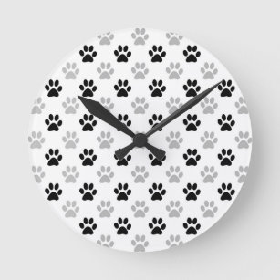 Black and white puppy paw prints round clock