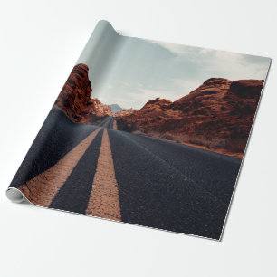 BLACK ASPHALT ROAD BETWEEN BROWN ROCK FORMATION UN WRAPPING PAPER