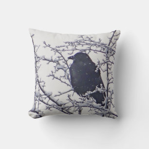 Black bird between snowy branches cushion