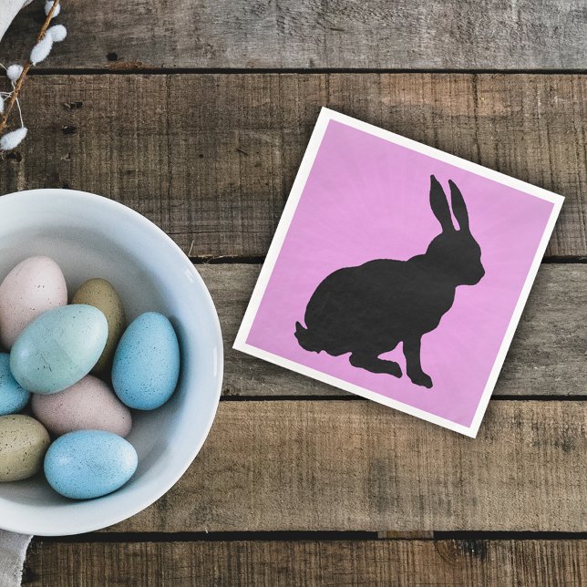 Black Bunny Silhouette Form Tall Ears on Pink Napkin (Sitting black silhouette bunny rabbit on pink paper napkin for spring time or Easter.)