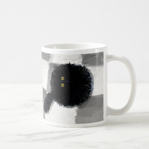 Black cat looking up coffee mug