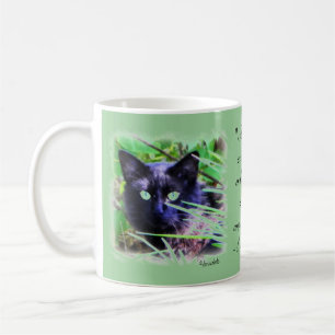 Black cat with striking green eyes coffee mug