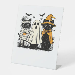 Black Cats in Halloween Costumes – Ghost, Witch, a Pedestal Sign