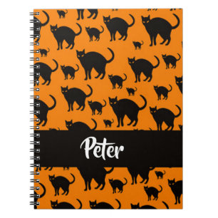 Black cats on orange notebook