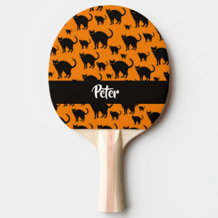 Black cats on orange ping pong paddle
