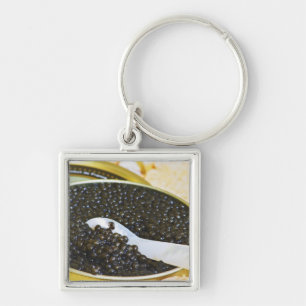 Black caviar and a spoon of mother-of-pearl to key ring